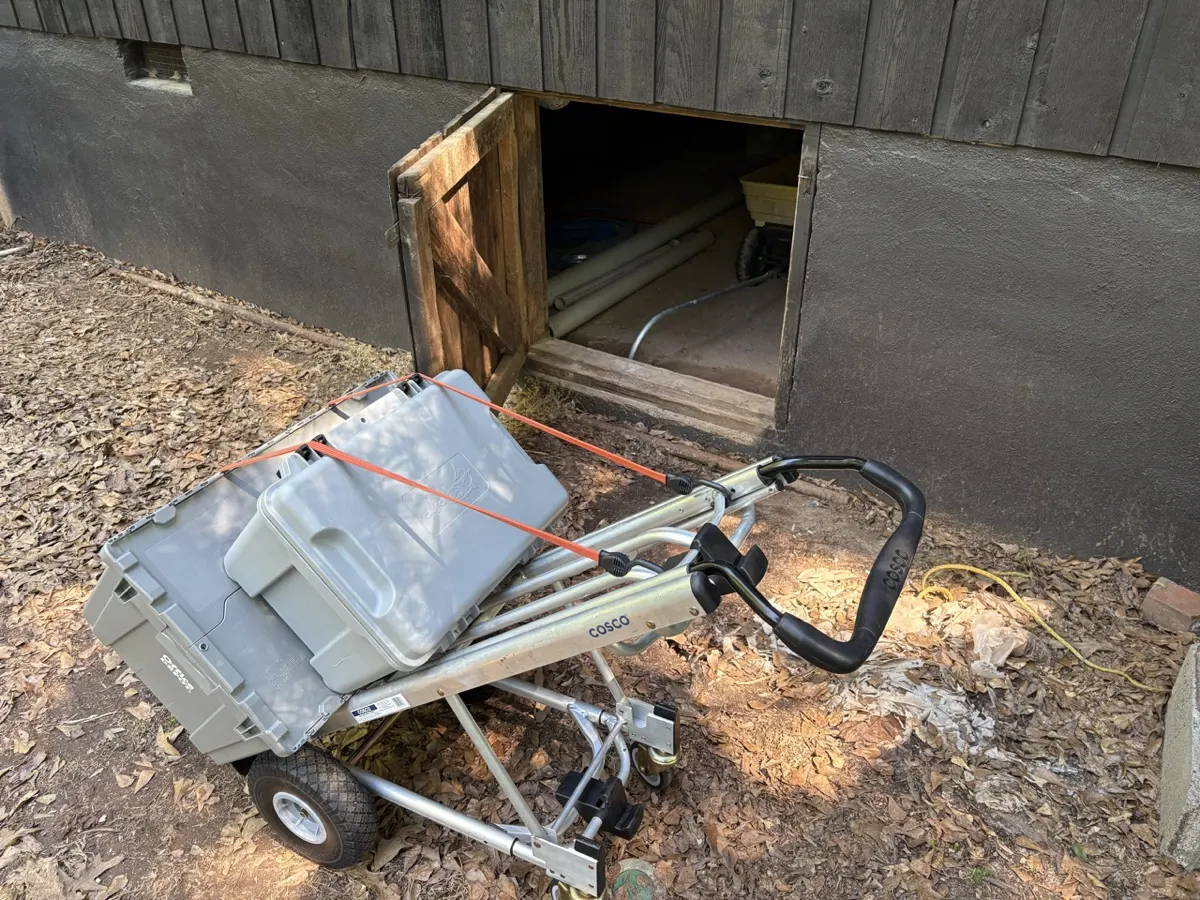 Kachug assessment gear staged at an open crawlspace access door